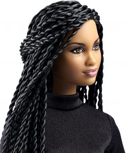 close up of light skinned black doll with long braids.