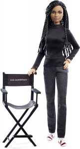 black Barbie doll standing next to a director's chair