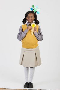 Smiling schoolgirl with a gecko hair ornament