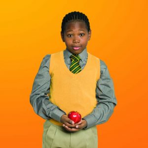 Sam in school uniform with apple for teacher