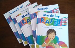 A stack of copies of the book "Made by Raffi" in different languages