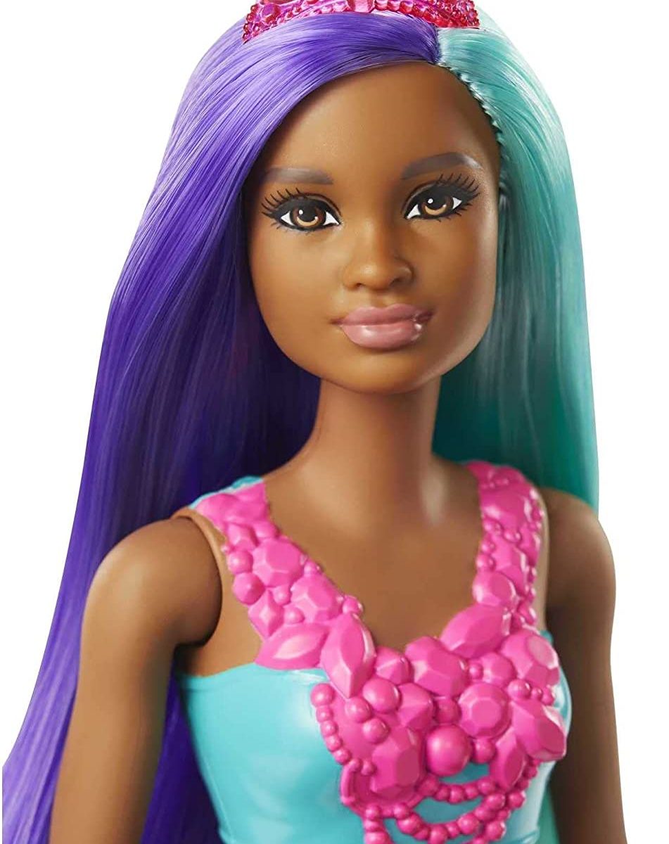 Face of a black mermaid doll with purple and blue hair.