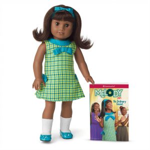 Black doll in 60s dress with book