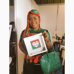 Congolese Irish woman with braids in the Mayo colours