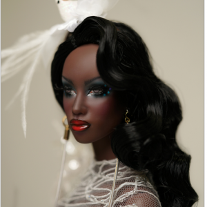 black haired doll with lavish make up and a dove in her hair
