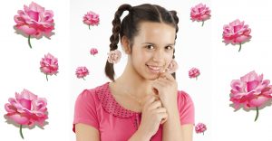 Pretty girl with sweet smile and rose hair clips.